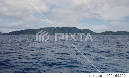 Side view from boat in Indian ocean sailing between Seychelles islands in daytime 135469461