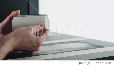 man hands check bottom of white ceramic glass 135469486