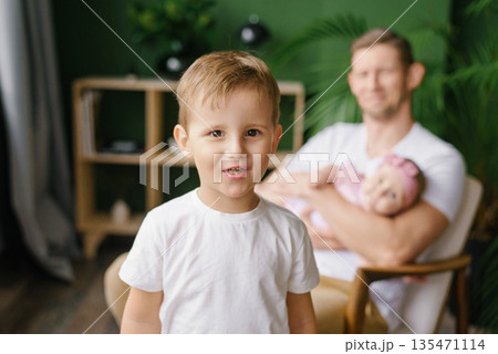 Happy Young Boy With Father And Baby At Home 135471114