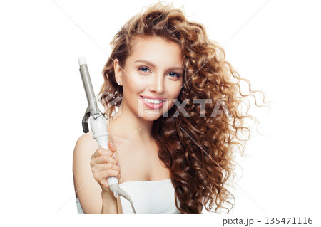 Isolated woman holding using hot curling tongs iron on white background. Isolated woman holding using hot curling tongs iron on white background. 135471116
