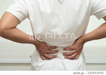 Asian man pain back muscle, spine and bone from accident. Asian man pain back muscle, spine and bone from accident. 135471470