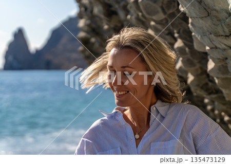 Woman Coastal Rocks Greece Summer Relaxation: Seascape portrait, sunny day, serene mood. Woman Coastal Rocks Greece Summer Relaxation: Seascape portrait, sunny day, serene mood. 135473129