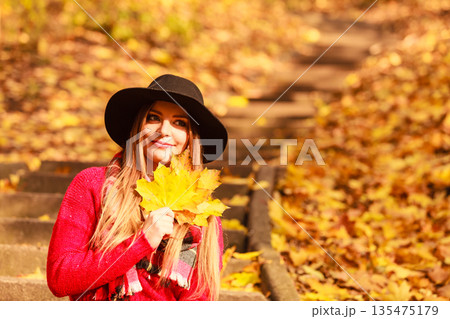 Woman relaxing in autumn fall park Woman relaxing in autumn fall park 135475179