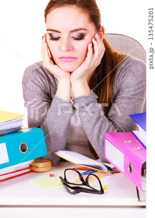 woman tired with stack of folders documents 135475201