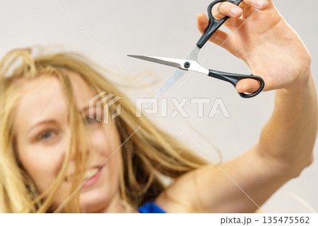 Woman with scissors ready to hair cutting Woman with scissors ready to hair cutting 135475562