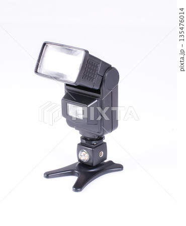 Flash for a camera on a white isolated background. Studio flash light Flash for a camera on a white isolated background. Studio flash light 135476014