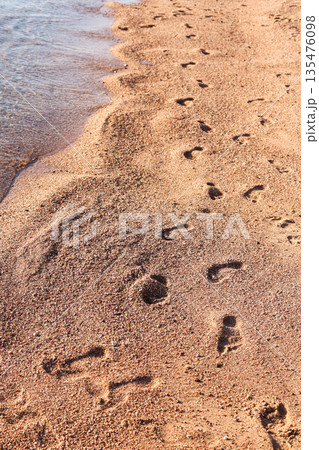 Footprints on the seashore, a symbol of serenity and a long-awaited vacation Footprints on the seashore, a symbol of serenity and a long-awaited vacation 135476098