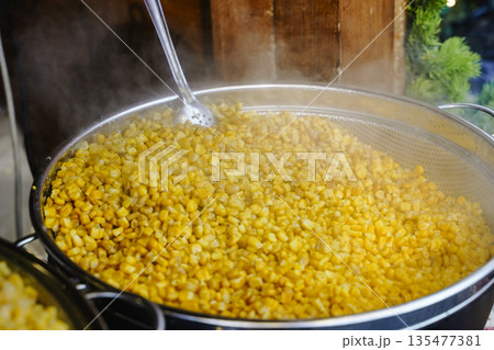 Hot Boiled Corn on the Cob in Large Pot at Street Food Market 135477381