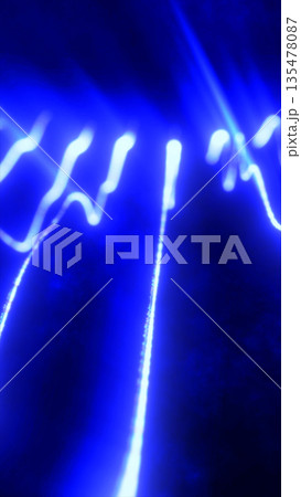 Abstract glowing blue light streaks forming dynamic flowing patterns on a dark background 135478087