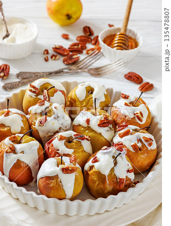 Tasty Baked Apples with Pecans and Cream Tasty Baked Apples with Pecans and Cream 135478807