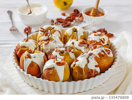 Tasty Baked Apples with Pecans and Cream 135478809