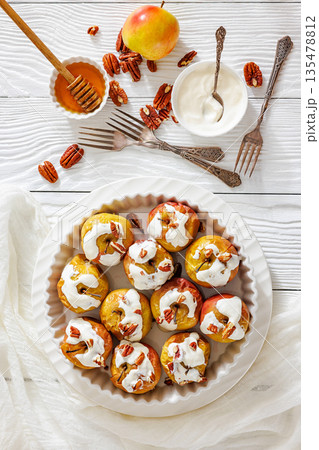 Tasty Baked Apples with Pecans and Cream Tasty Baked Apples with Pecans and Cream 135478812