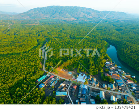 Aerial view top view of the fisherman village with fishing boats and house roof at the pier in Phangnga Thailand, Panorama high angle view 135479421