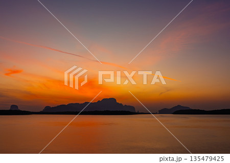 Aerial view sunset sky,Nature light Sunset or sunrise over sea,Colorful scenery sunset sky background,Amazing cloud background Aerial view sunset sky,Nature light Sunset or sunrise over sea,Colorful scenery sunset sky background,Amazing cloud background 135479425