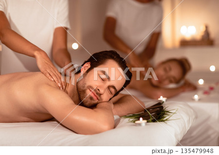 Relaxed Couple Enjoying Massage And Herbal Aromatherapy Lying In Luxury Spa Center Indoor. Body Care And Beauty Treatment, Wellness And Relaxation Concept. Selective Focus Relaxed Couple Enjoying Massage And Herbal Aromatherapy Lying In Luxury Spa Center Indoor. Body Care And Beauty Treatment, Wellness And Relaxation Concept. Selective Focus 135479948