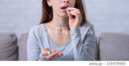 Desperate young woman suffering from depression, ovrdosing on pills, committing suicide at home. Stressed millennial lady having nervous breakdown, emotional burnout, going through personal crisis 135479993