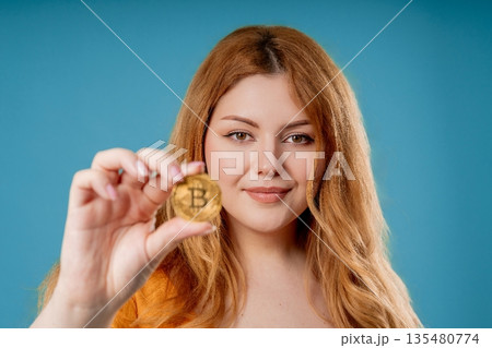 Plus Size Woman Bitcoin, Crypto Currency. Golden Coin On Blue Background. Btc Plus Size Woman Bitcoin, Crypto Currency. Golden Coin On Blue Background. Btc 135480774