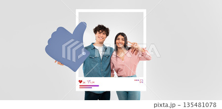 Two young influencers smile happily while posing with a thumbs-up sign, promoting online engagement and interaction. Their casual attire and cheerful expressions create a vibrant atmosphere. Two young influencers smile happily while posing with a thumbs-up sign, promoting online engagement and interaction. Their casual attire and cheerful expressions create a vibrant atmosphere. 135481078