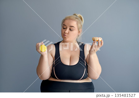 An obese woman is faced with the choice of being thin and exercising, or enjoying donuts and sweets. Proper nutrition and sports An obese woman is faced with the choice of being thin and exercising, or enjoying donuts and sweets. Proper nutrition and sports 135481527