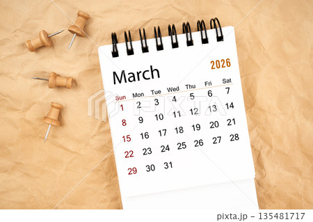 March 2026 white desk calendar with wooden thumbtack on old  crumpled paper. 135481717