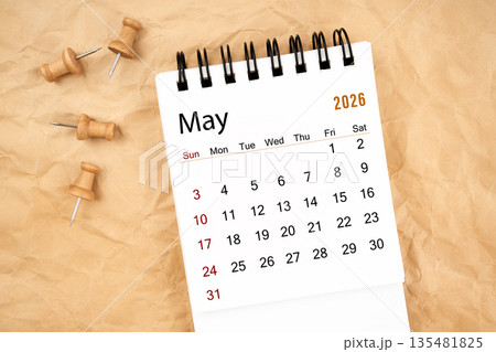 May 2026 white desk calendar with wooden thumbtack on old crumpled paper. May 2026 white desk calendar with wooden thumbtack on old crumpled paper. 135481825