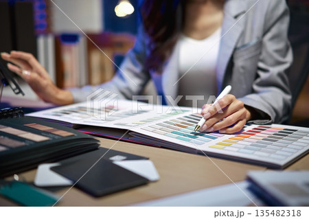 interior designer working on new house project in office. choosing materials and colors from samples interior designer working on new house project in office. choosing materials and colors from samples 135482318