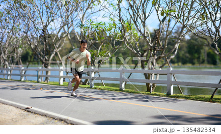 Asian sportsman running in the park, New year resolution health care Asian sportsman running in the park, New year resolution health care 135482334