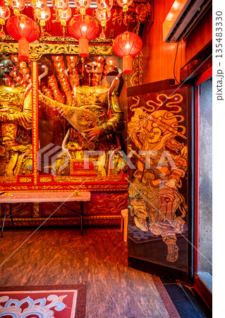Golden Chinese-style Bodhisattva statues and ornate red interior decorations at Wat Mangkon Kamalawat during a spiritual ceremony 135483330