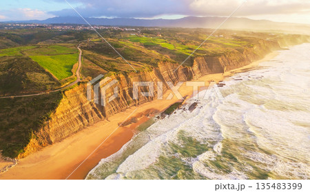 Magoito Beach and Cliffs at Sunset. Atlantic Ocean, Portugal. Aerial View Magoito Beach and Cliffs at Sunset. Atlantic Ocean, Portugal. Aerial View 135483399
