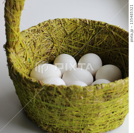 Woven Basket With Grass Fibers With Whole White Eggs 135485321