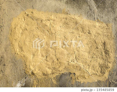 Rough dry concrete textured wall with yellow patch and cracks outdoors 135485859