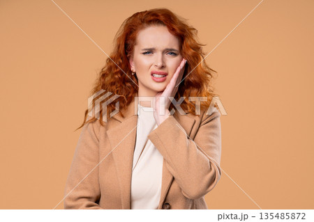 Young Businesswoman With Tooth Pain, Beige Background.toothache, Dental Problem  135485872