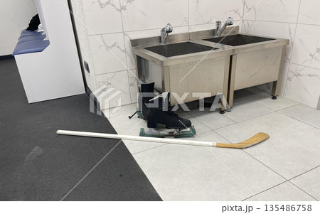 sportswear and skates for a hockey player in the team's locker room 135486758