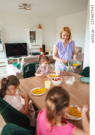 Joyful family gathering around a dining table in harmony 135487541