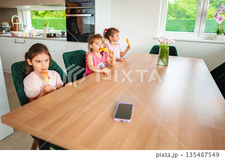 Enjoying colorful treats in a cozy kitchen setting Enjoying colorful treats in a cozy kitchen setting 135487549