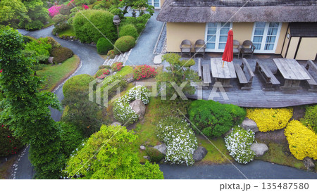 Aerial view on rhododendron blossoms (white and pink) and part of Japanese house Aerial view on rhododendron blossoms (white and pink) and part of Japanese house 135487580