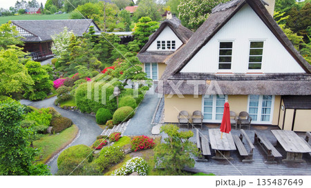 Aerial view on topiary: pruned plants and houses in Japanese style in distance in Odense Japanese garden Aerial view on topiary: pruned plants and houses in Japanese style in distance in Odense Japanese garden 135487649