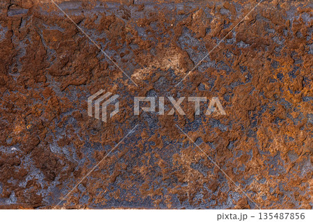 Rough textured rust surface in natural outdoor setting 135487856