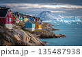 Colorful Arctic Village on Rocky Shore with Icebergs 135487938