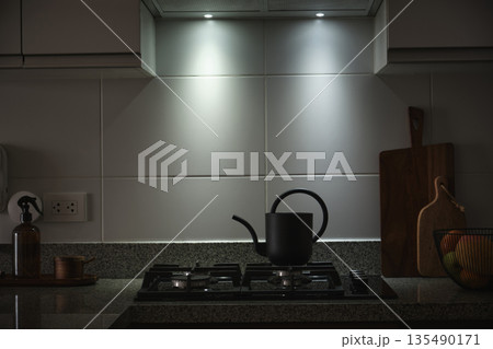 Modern kitchen interior with dark kettle on gas stove Modern kitchen interior with dark kettle on gas stove 135490171