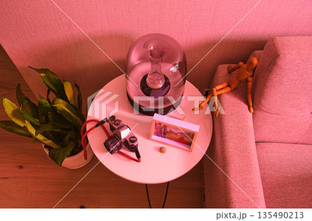 Cozy domestic scene with speaker and film camera on a table 135490213