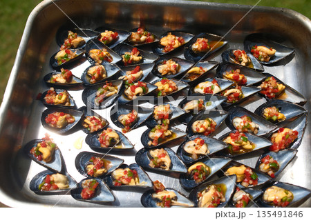 Fresh steamed mussels served in shell with broth or lemon. 135491846
