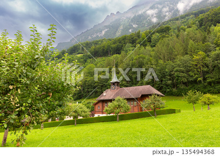 Wooden building with clock tower in Iseltwald Switzerland 135494368