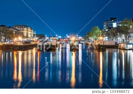 Nighttime Canal Reflections in Amsterdam, Netherlands Cityscape Lights and Water Scenery Nighttime Canal Reflections in Amsterdam, Netherlands Cityscape Lights and Water Scenery 135498072