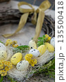 Handmade Easter wreath festive yellow egg decorations. Traditional holiday preparation craft master class of creative making decor. Hands-on activities sustainable responsible holiday gift workshop 135500418