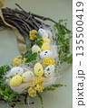 Handmade Easter wreath made of sustainable materials decorations in yellow color. Homemade decor Easter celebration gift present ideas. Copy space 135500419