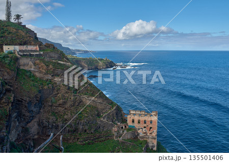 Historic ruins of the Gordejuela Water Pumping Station perched on a verdant cliff overlooking the vast Atlantic Ocean on the island of Tenerife Historic ruins of the Gordejuela Water Pumping Station perched on a verdant cliff overlooking the vast Atlantic Ocean on the island of Tenerife 135501406