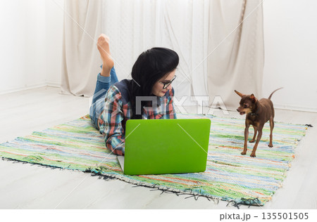 Girl at home with laptop and dog chihuahua. Hipster freelancer woman works at home. Home office, freelance. Girl at home with laptop and dog chihuahua. Hipster freelancer woman works at home. Home office, freelance. 135501505