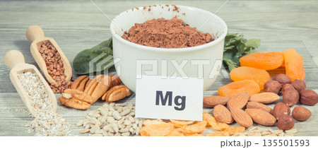 Inscription Mg, healthy food containing natural magnesium, fiber and other vitamins or minerals 135501593
