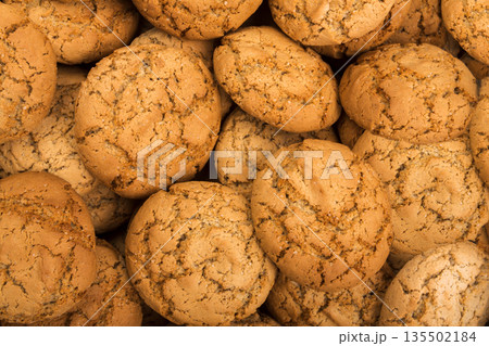 Cookies background. Oatmeal biscuits texture background. Fattening sweets concept 135502184